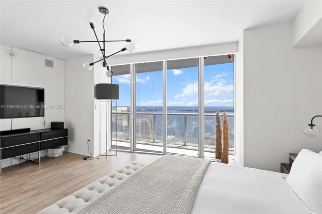 a bedroom with a bed and glass window