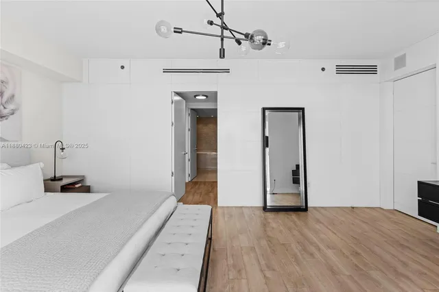 a view of a room with wooden floor and a ceiling fan