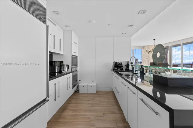 a kitchen with kitchen island granite countertop lots of counter top space and stainless steel appliances