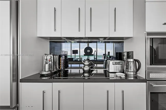 a kitchen with refrigerator and cabinets
