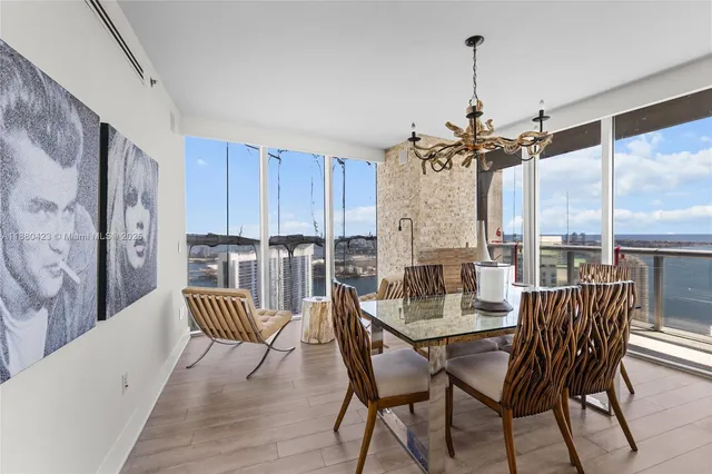 a dining room with furniture window and wooden floor