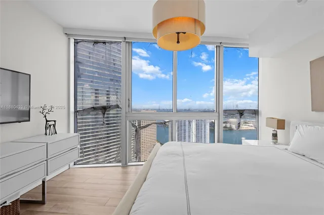 a bedroom with a bed and a chandelier