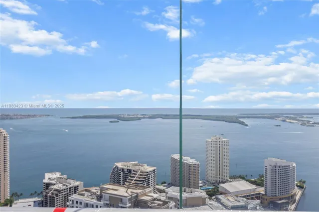 a kitchen with kitchen island granite countertop a sink appliances and cabinets