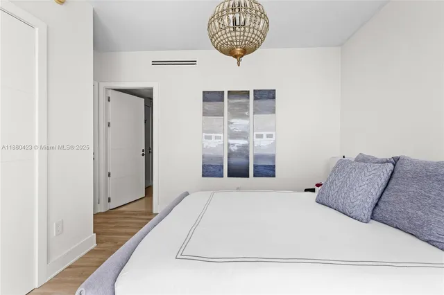 a large white bed in a white room