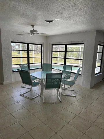 a living room with furniture and floor to ceiling windows
