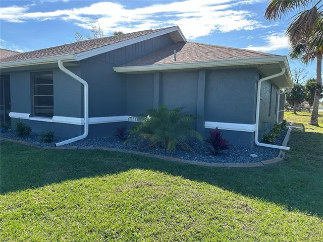 a view of backyard of house with green space