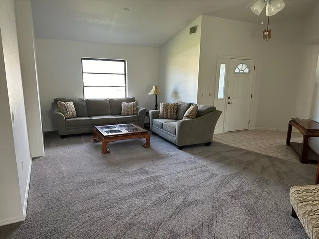 a living room with furniture and a window