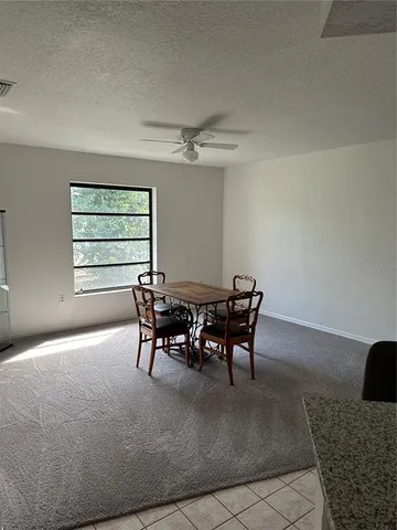 a dining room with furniture and window