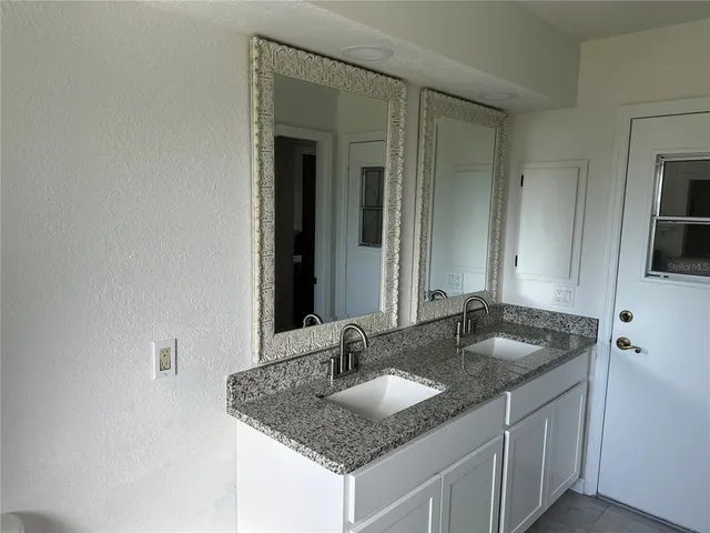 a bathroom with sinks granite countertop a sink and a mirror