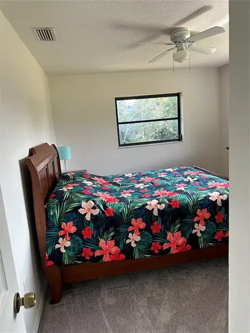 a bed sitting in a bedroom next to a window