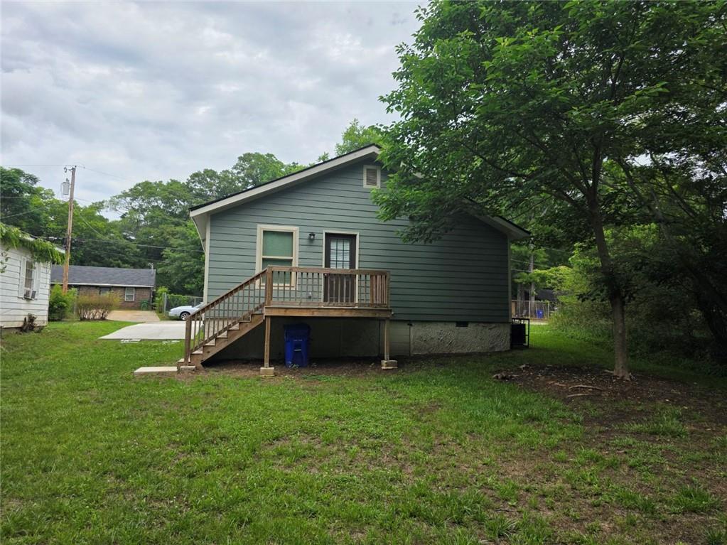 722 Lacy Street Monroe, GA 30655 - Photo 3 of 19 a view of a house with a backyard