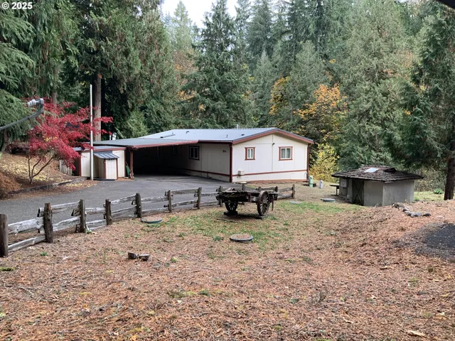 a backyard of a house with table and chairs