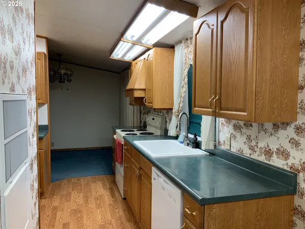 a kitchen with a sink a stove and a refrigerator