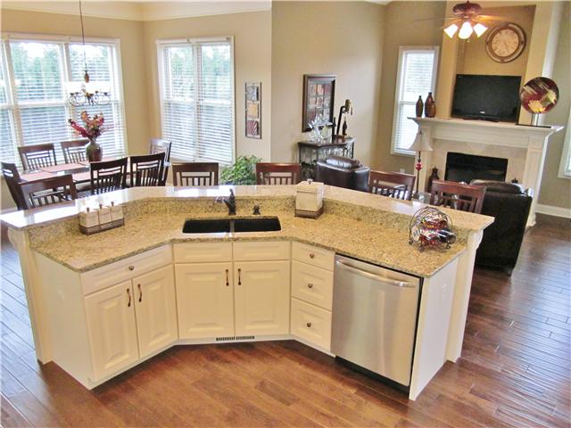 4799 Sango Road Clarksville, TN 37043 - Photo 11 of 20 a view of living room with kitchen island furniture a fireplace and a large window
