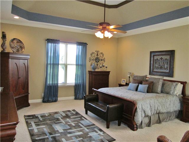 4799 Sango Road Clarksville, TN 37043 - Photo 15 of 20 a bedroom with a bed and a chandelier