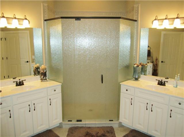 4799 Sango Road Clarksville, TN 37043 - Photo 16 of 20 a bathroom with a double vanity sink mirror and shower