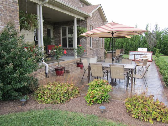 4799 Sango Road Clarksville, TN 37043 - Photo 3 of 20 a view of a patio with table and chairs under an umbrella