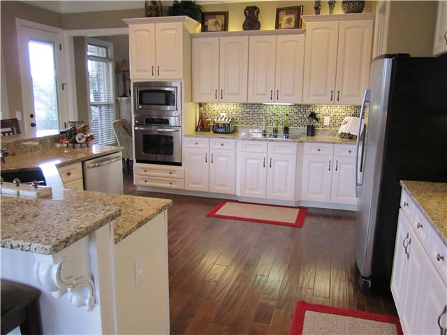 4799 Sango Road Clarksville, TN 37043 - Photo 10 of 20 a kitchen with stainless steel appliances granite countertop a refrigerator sink and stove