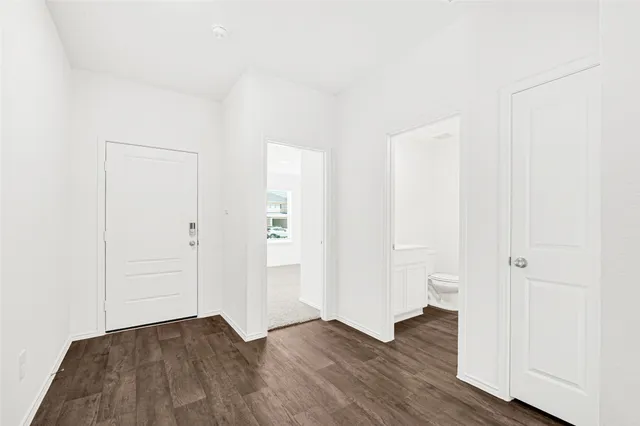 an empty room with wooden floor and closet