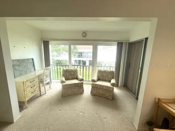 a living room with furniture and a large window