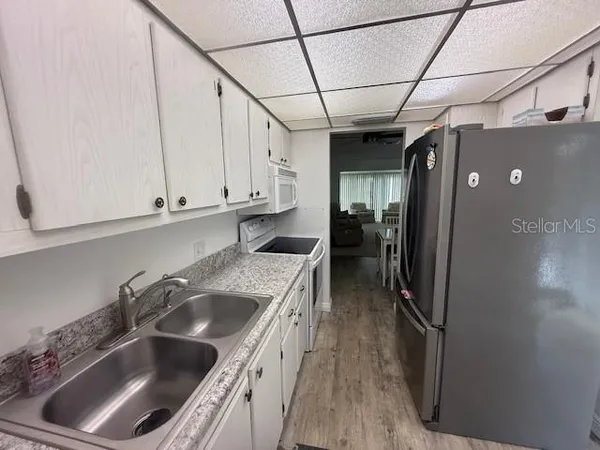 a kitchen with a sink stove and cabinets