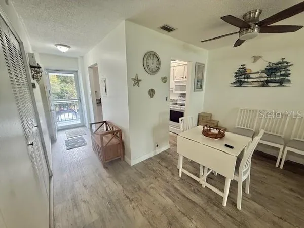 a view of a dining room with furniture and wooden floor