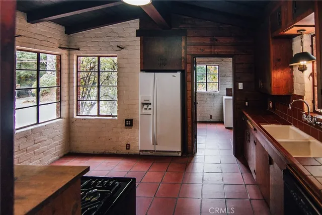 a kitchen with granite countertop a stove and a refrigerator