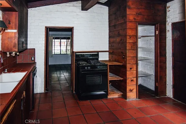 a kitchen with a sink stove and cabinets