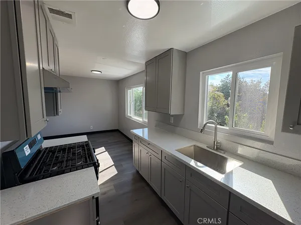 a kitchen with a sink and cabinets