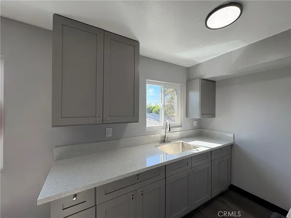 a kitchen with sink cabinets and window