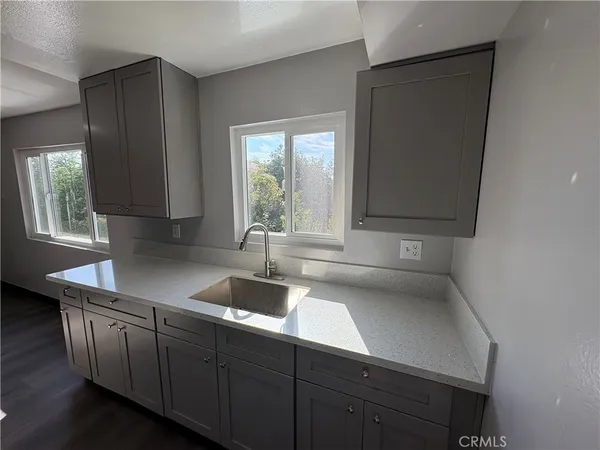 a kitchen with granite countertop a stove and a cabinets