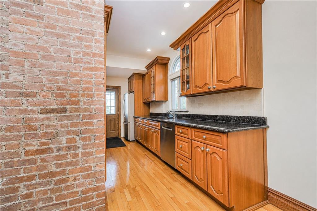 1352 Bay Ridge Parkway Brooklyn, NY 11228 - Photo 20 of 42 a kitchen with stainless steel appliances granite countertop a stove a sink and a microwave