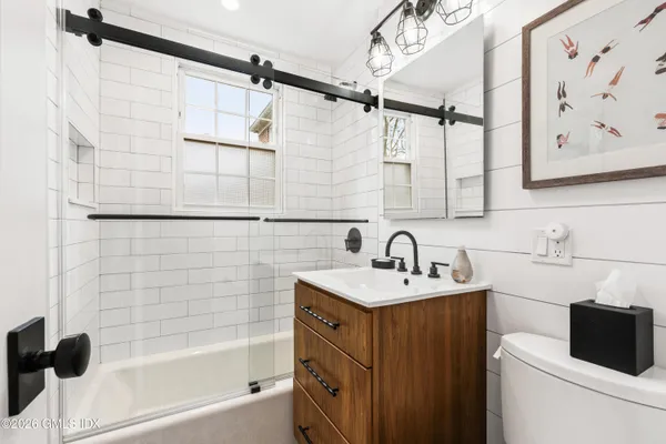 a bathroom with a sink toilet tub and shower