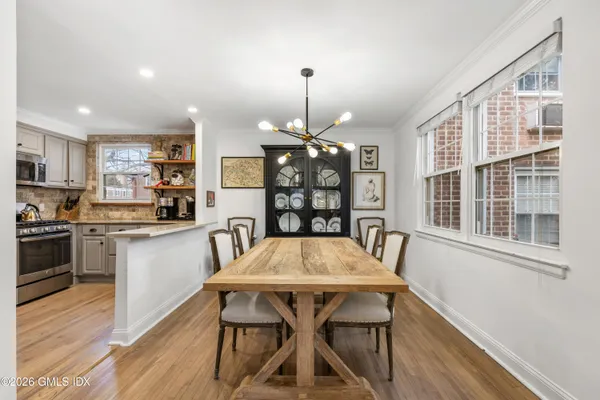 a view of a dining room with furniture window and wooden floor