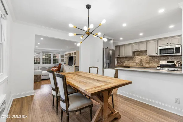 a view of a dining room with furniture and a kitchen view