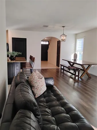 a room with furniture a window and wooden floor