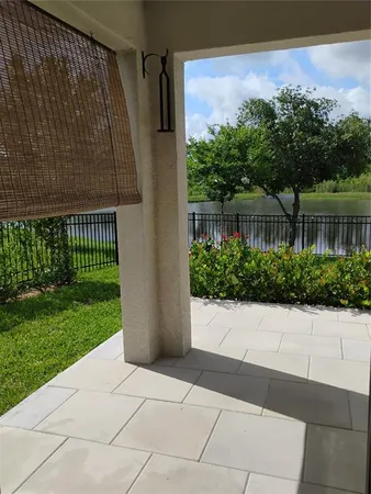 a front view of a house with garden and trees