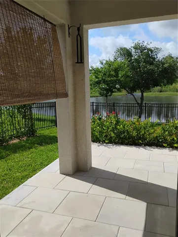 a front view of a house with garden and trees