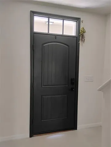 a bedroom with a bed and lamp