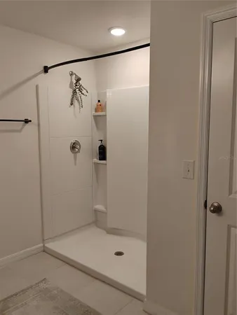 a view of a swimming pool and a table and chairs under an umbrella