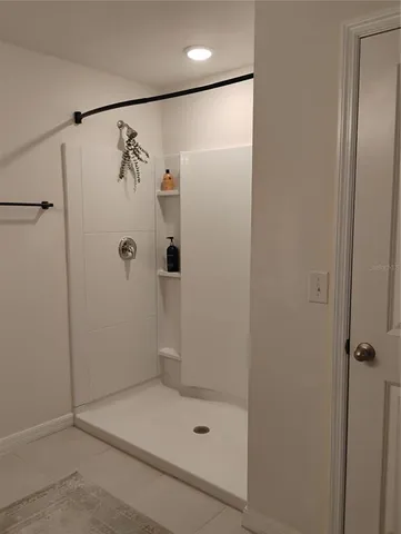 a view of a swimming pool and a table and chairs under an umbrella