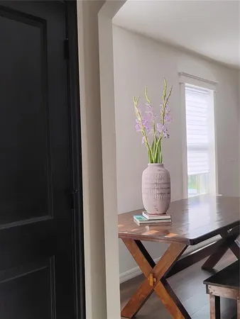 a dining room with furniture a chandelier and wooden floor