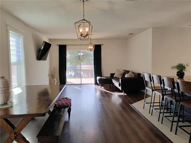 a view of a kitchen with stainless steel appliances granite countertop a refrigerator and a stove top oven