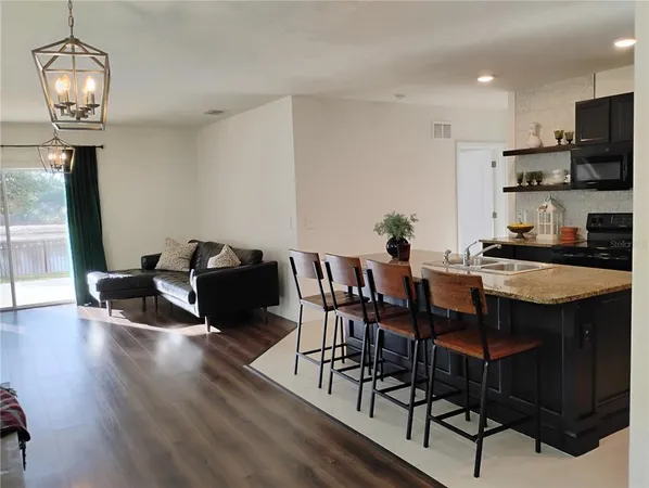 a dining room with furniture and a kitchen view