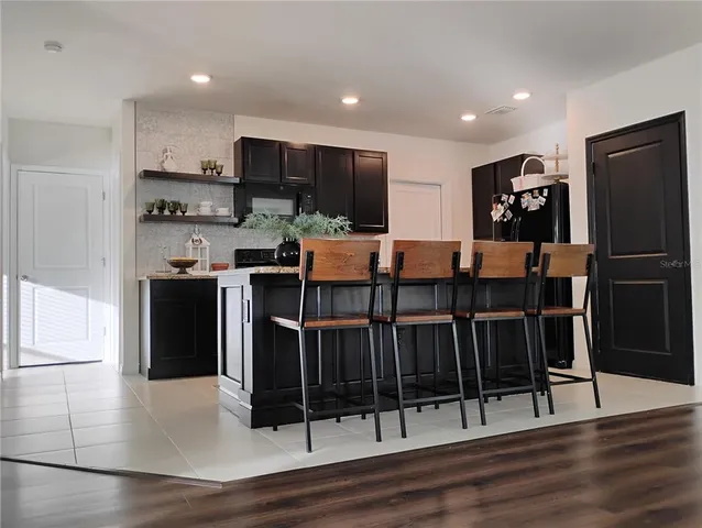 a kitchen with stainless steel appliances granite countertop a sink stove and cabinets