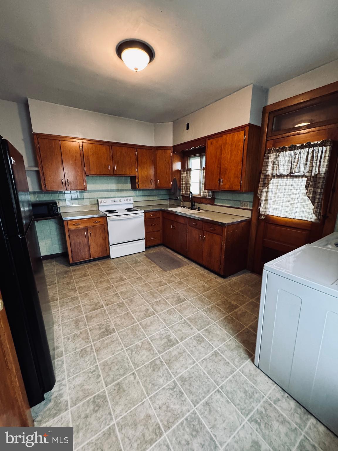 1137 West Main Street Valley View, PA 17983 - Photo 4 of 21 a kitchen with stainless steel appliances wooden cabinets and a stove top oven