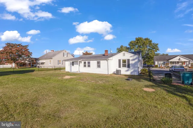 a view of a house with a backyard porch and sitting area