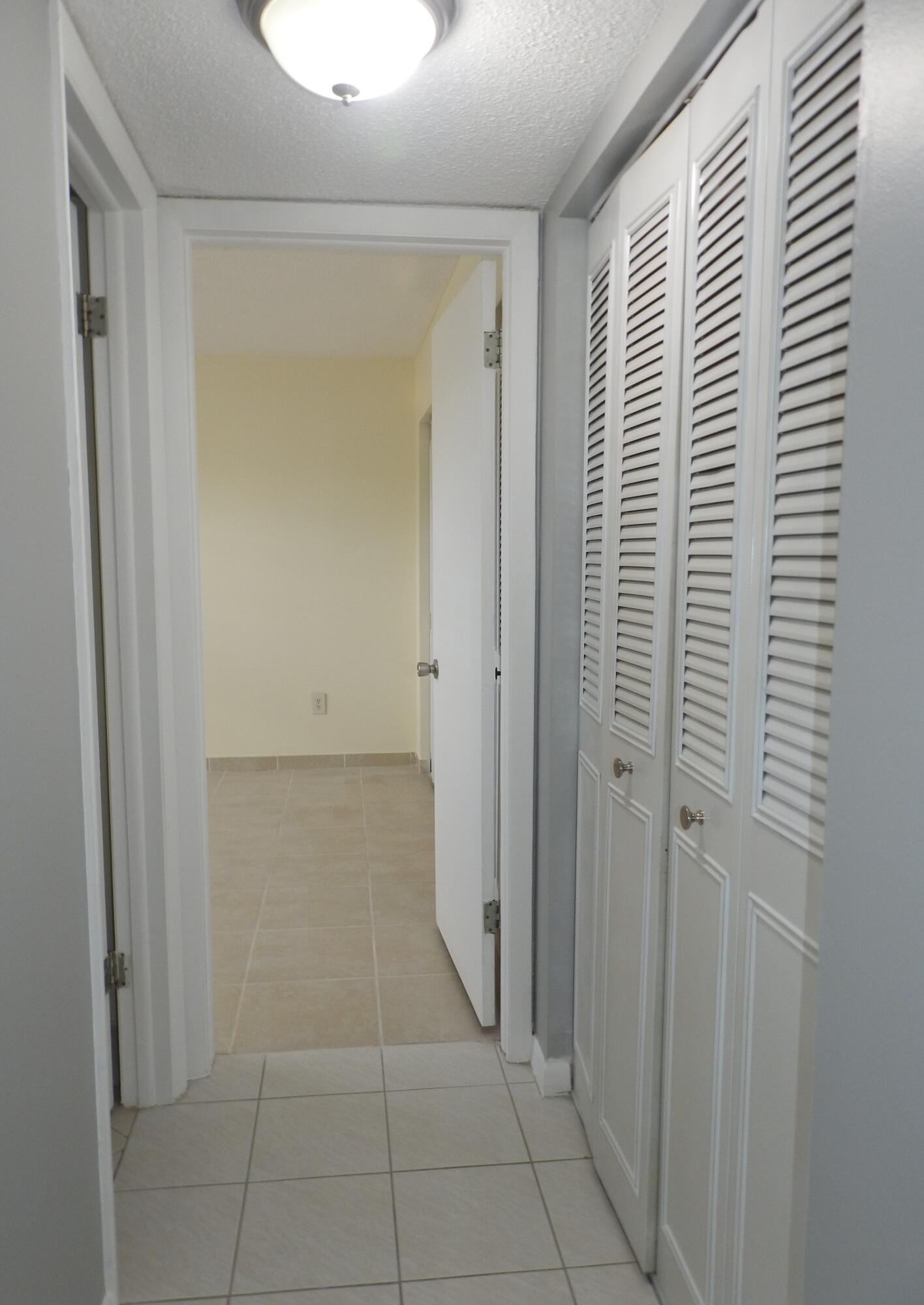 2600 Fiore Way, Unit 210 Delray Beach, FL 33445 - Photo 24 of 38 Hallway to 2nd. Bedroom
