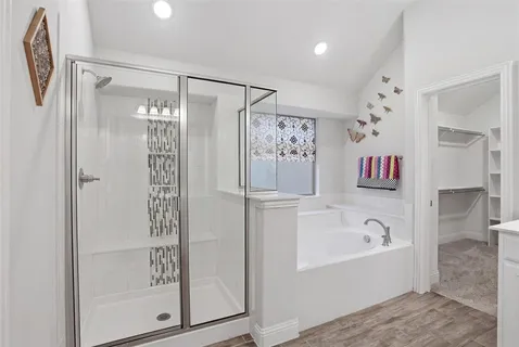 a bathroom with a bathtub and a shower