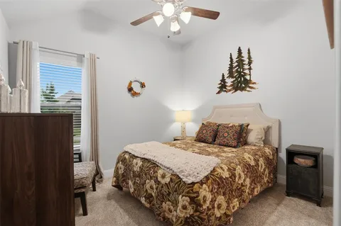a bedroom with a large bed and a chandelier